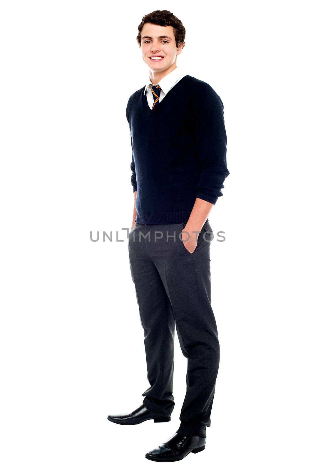 Full length portrait of a school going youngster with hands in pocket posing casually