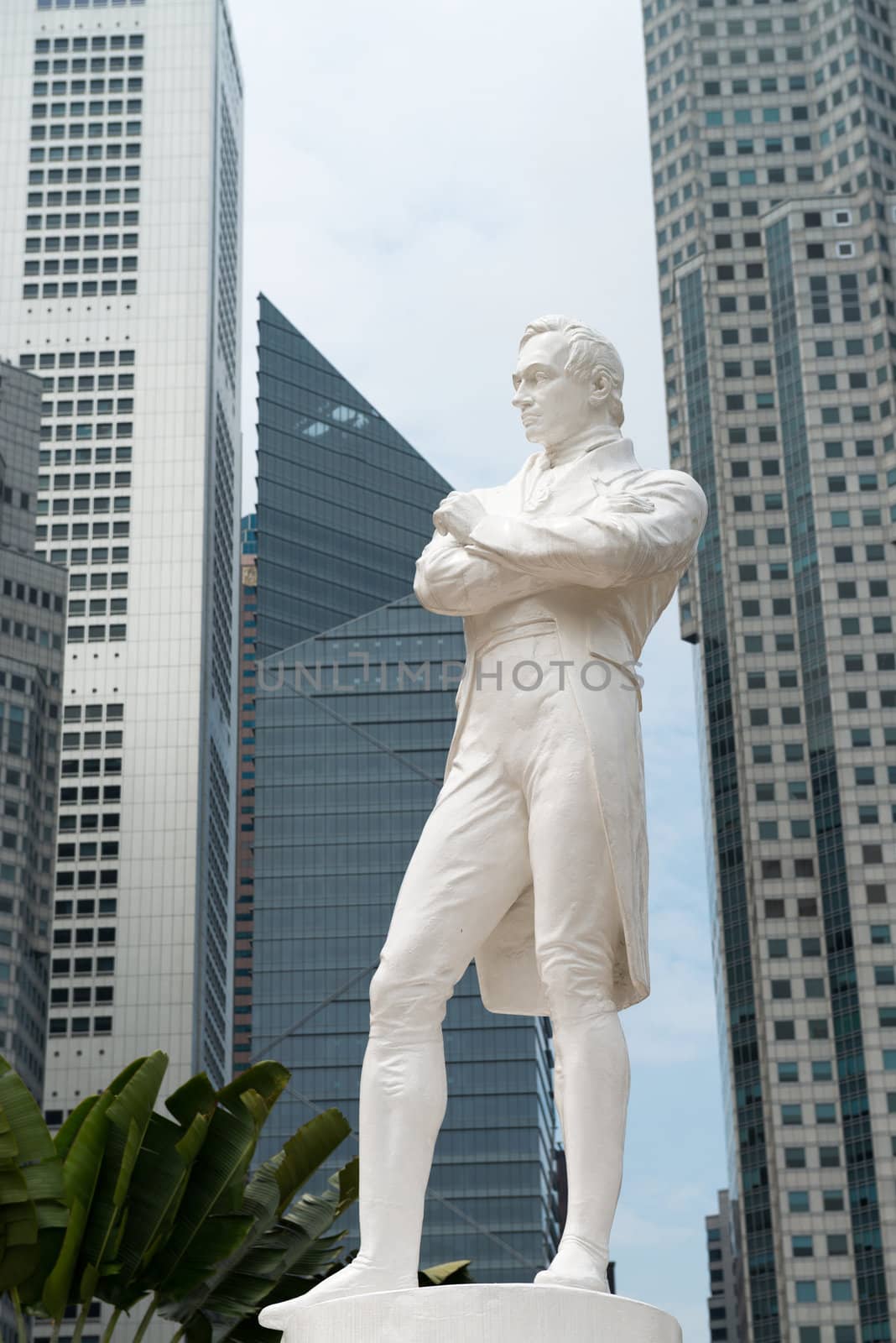 Sir Raffles statue with modern skyscrapers on background, Singapore