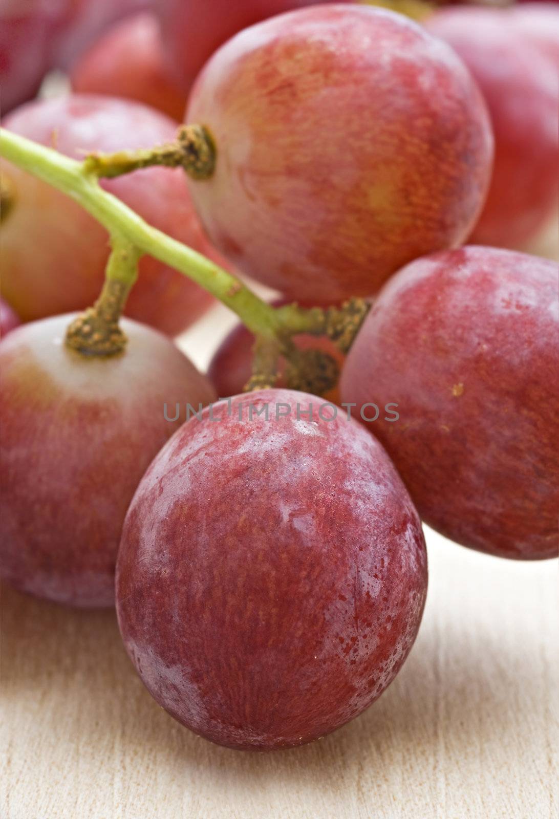 Bunch of red grapes on a wooden background