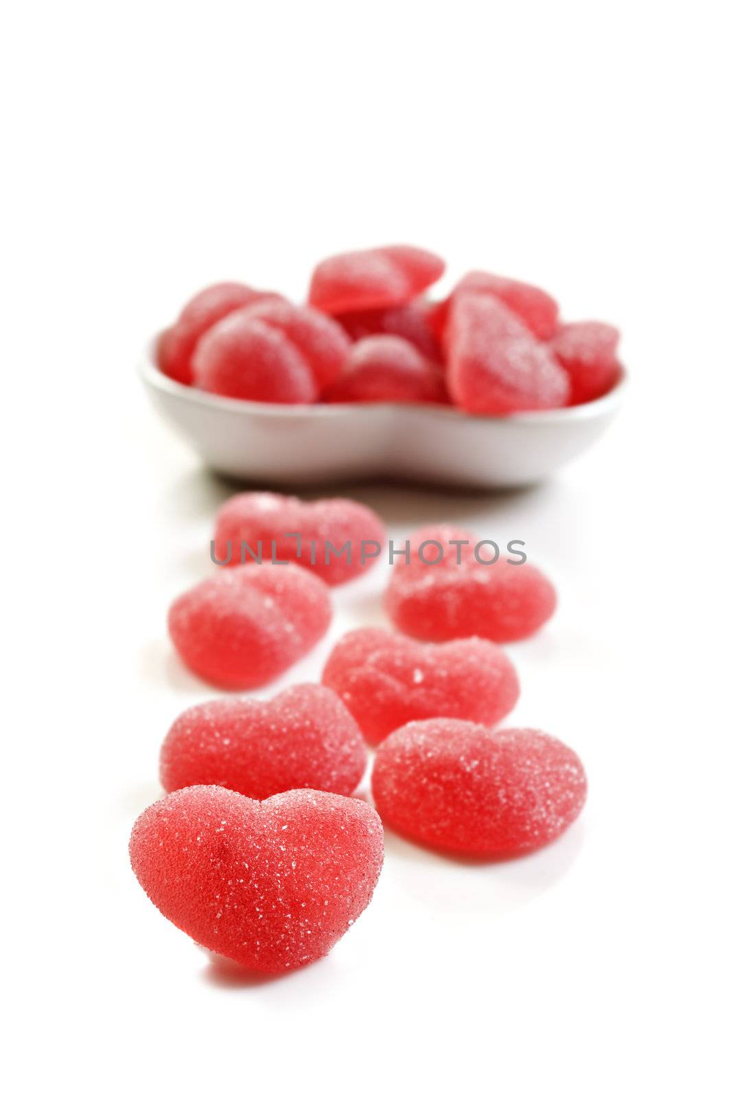 Red heart shaped sweets on a pure white background