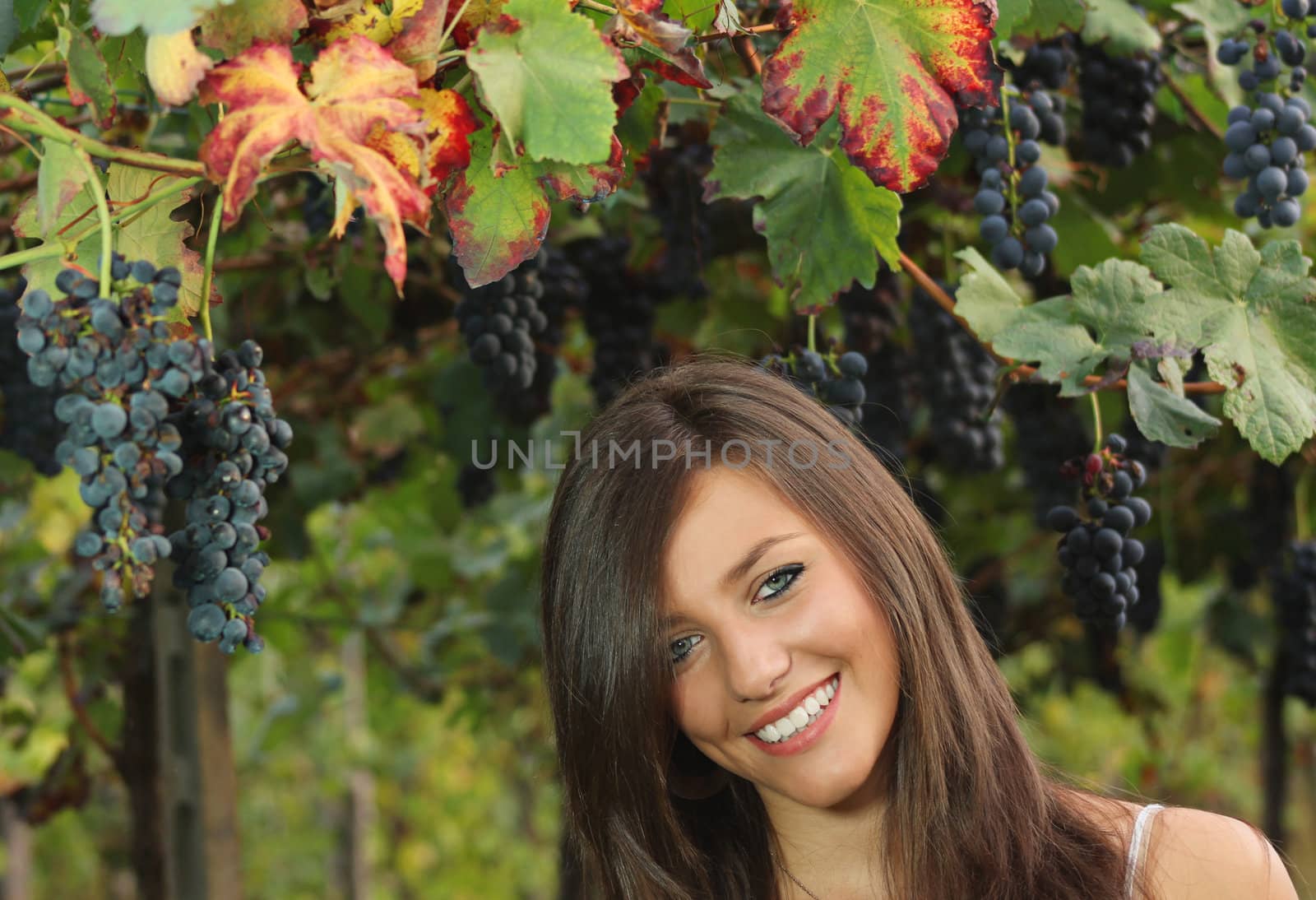Smiling girl with  grape  leaves by captblack76