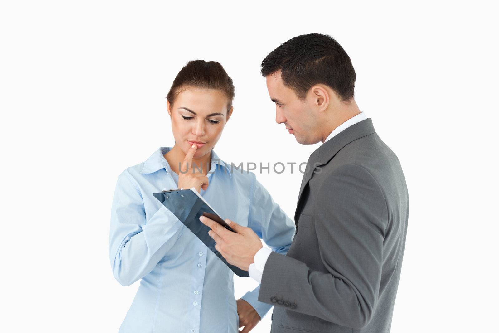Business partners with clipboard against a white background