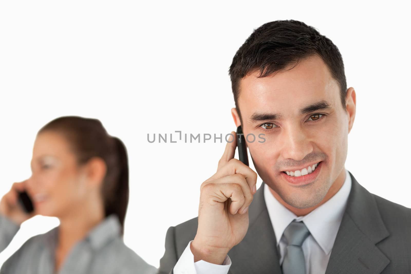 Close up of business partners on the phone against a white background
