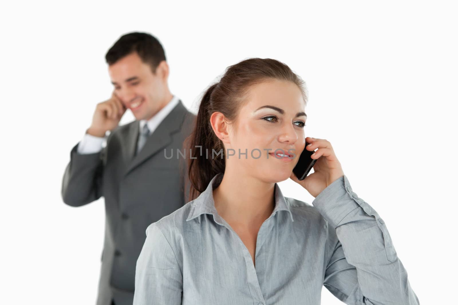 Close up of business partners talking on the phone against a white background