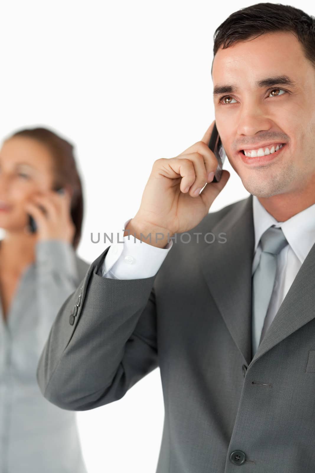 Close up of business team on the phone against a white background