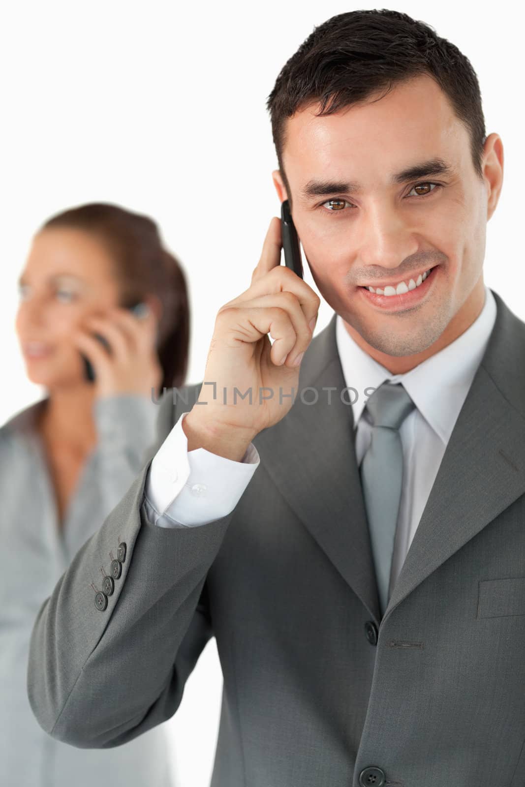 Close up of colleagues on the phone against a white background