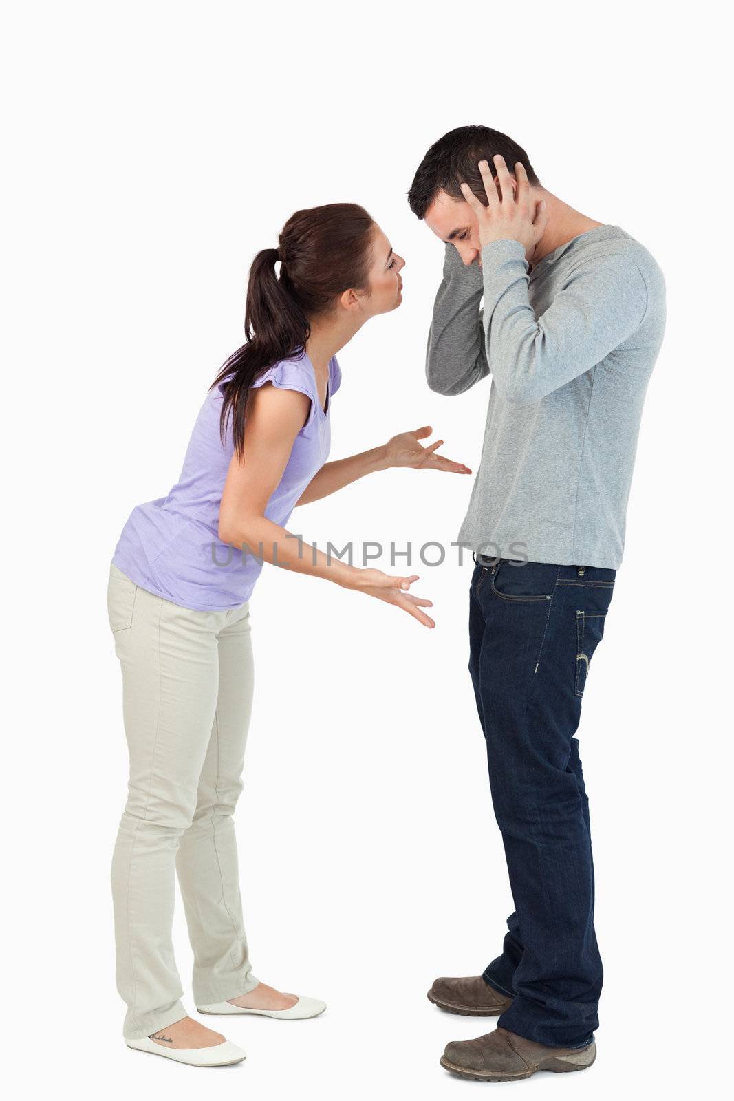 Young couple in a fight against a white background