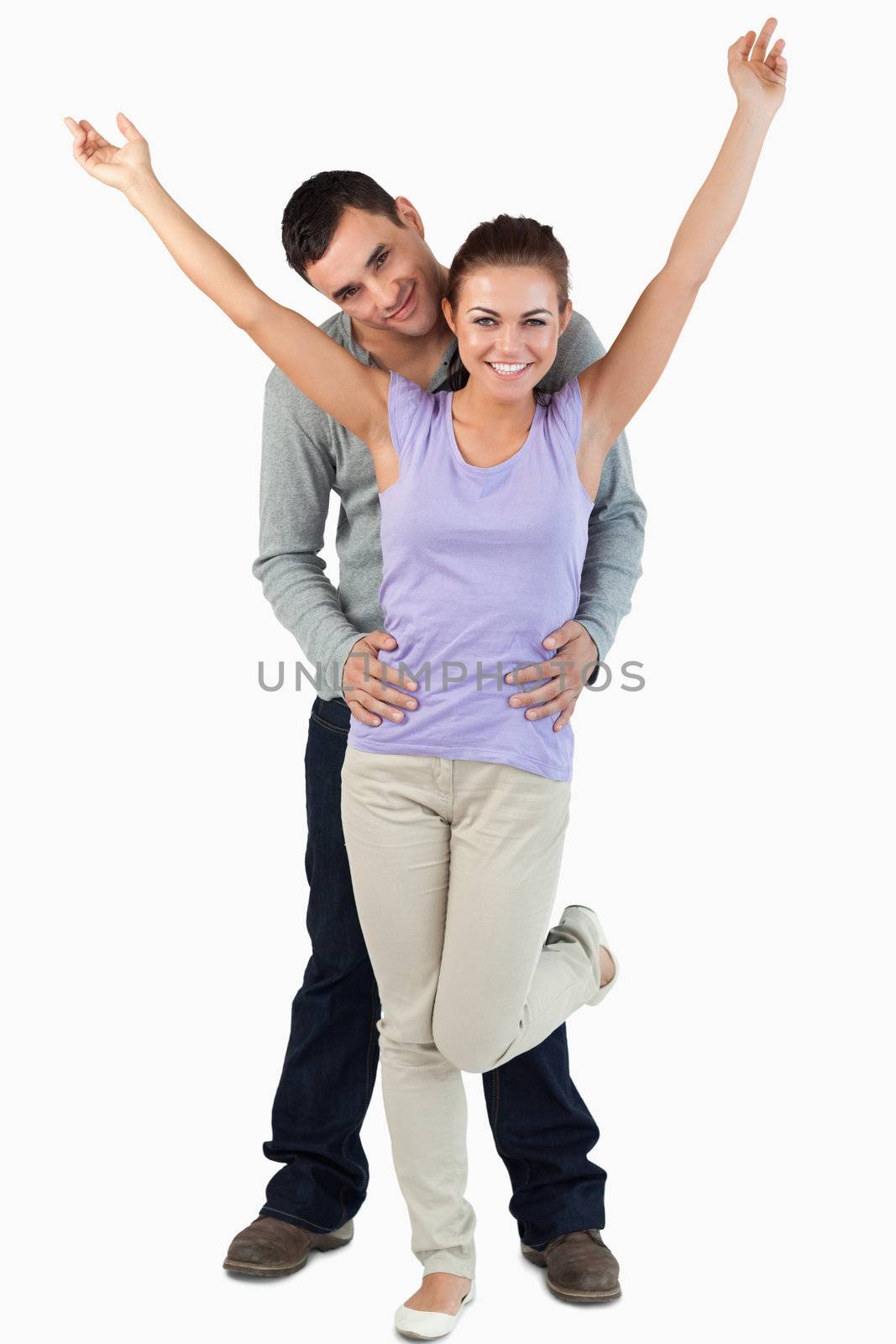 Happy young couple against a white background