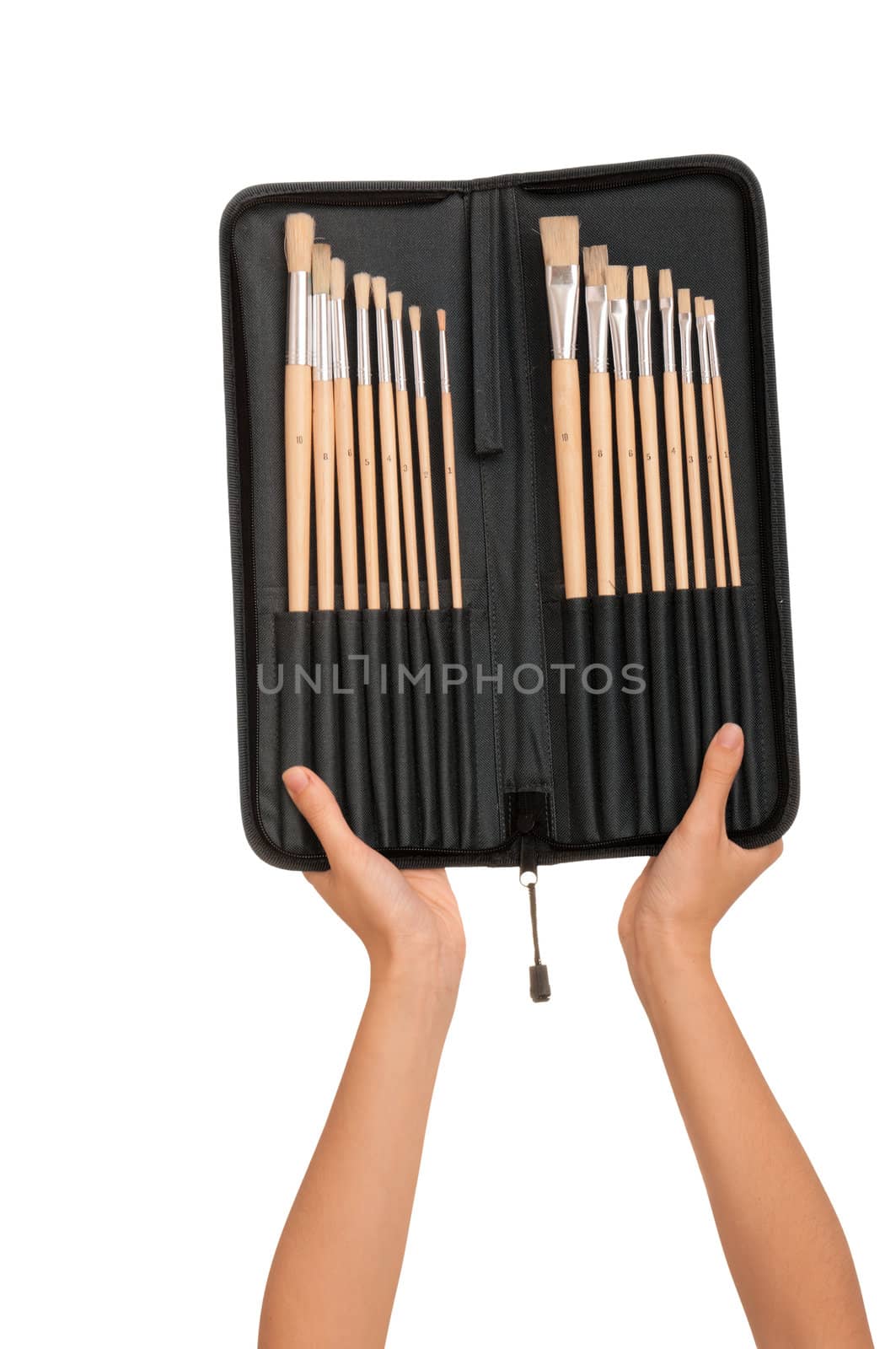 The woman chooses from a set of brushes one for drawing