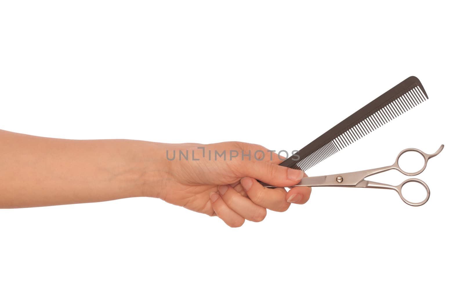 hairdresser holds scissors and hairbrush for haircut