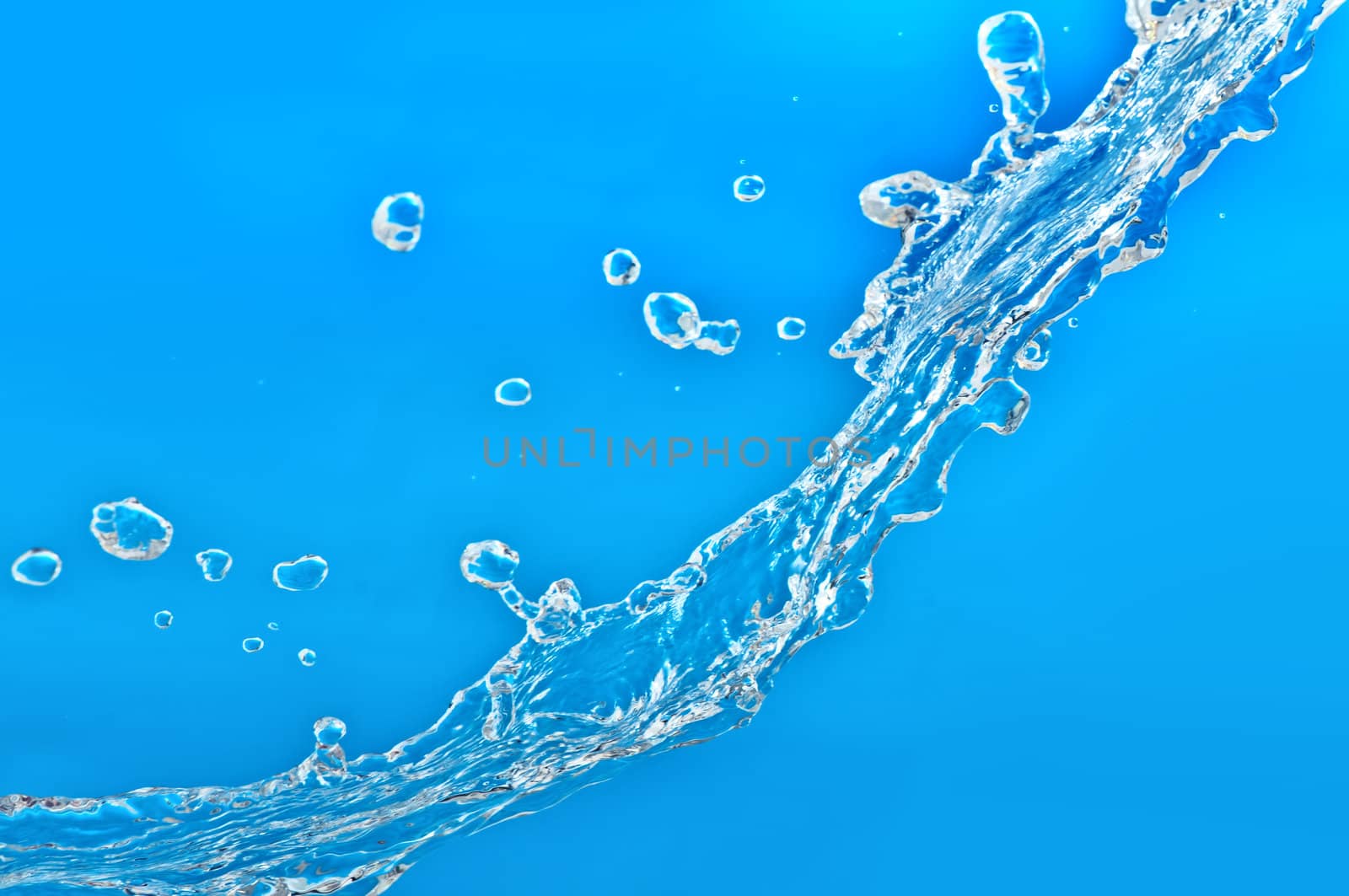pouring fresh tropical blue sea water in a glass aquarium