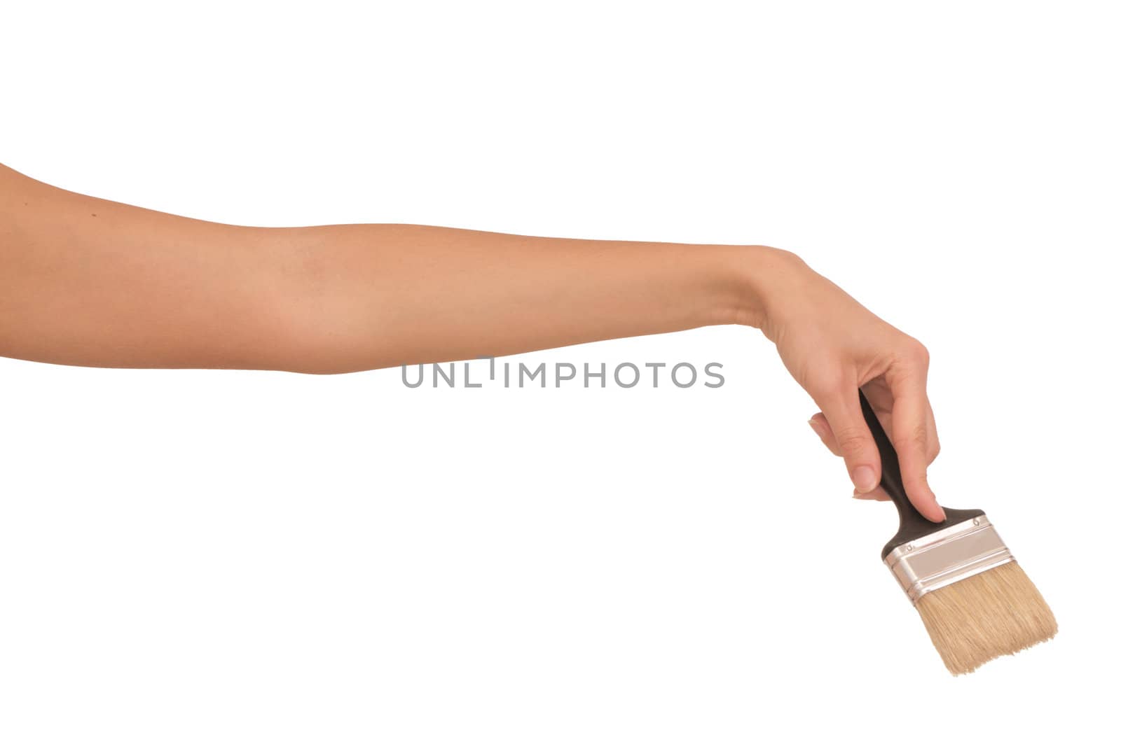 The woman draws the brush on the wall