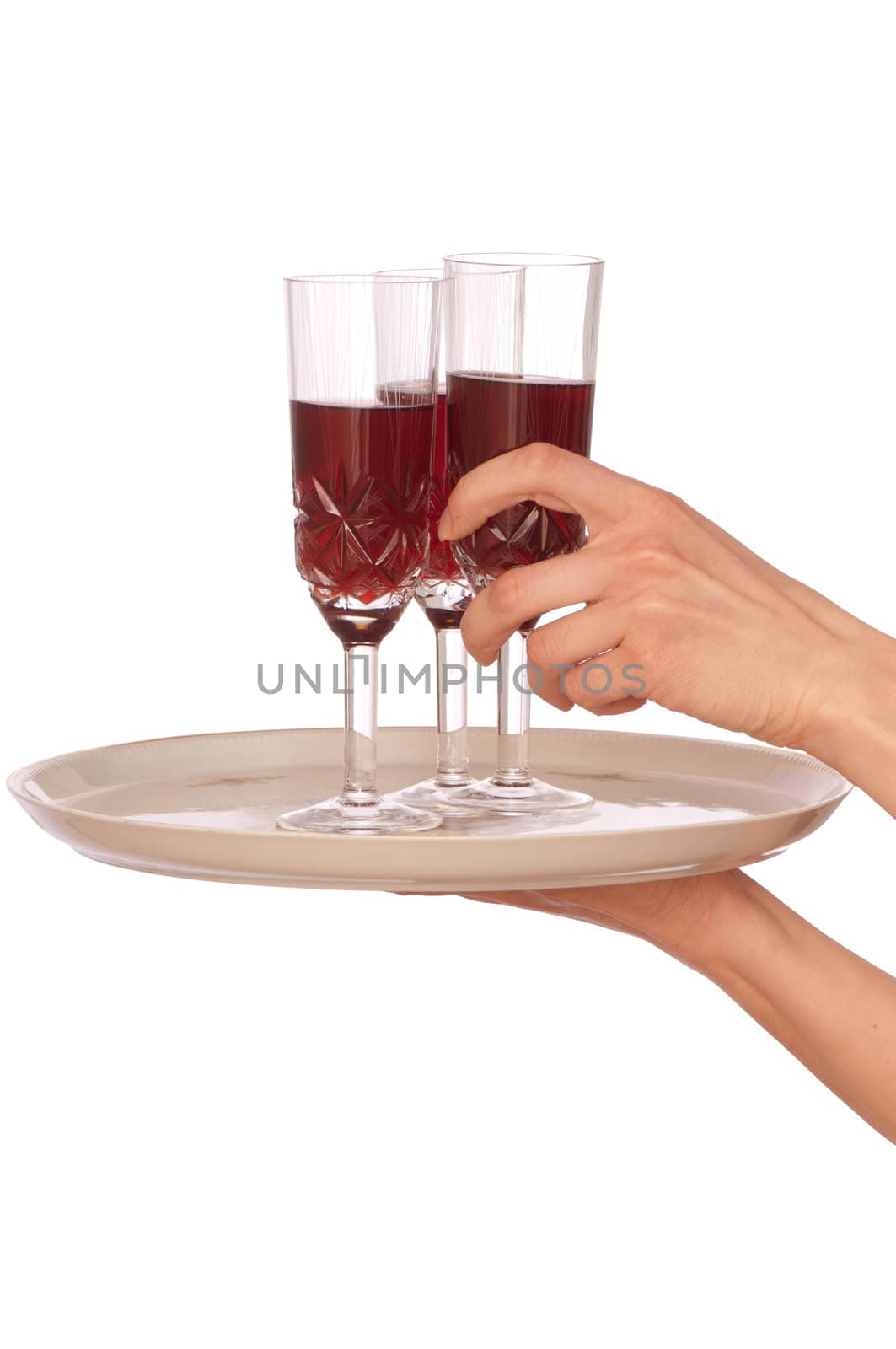 A waiter takes a glass of champagne from a tray with three glasses