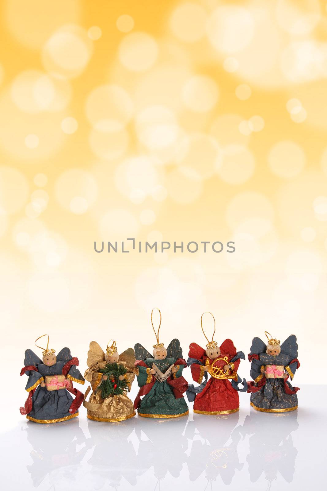 Decorative christmas angels with golden bokeh effect. Copy space