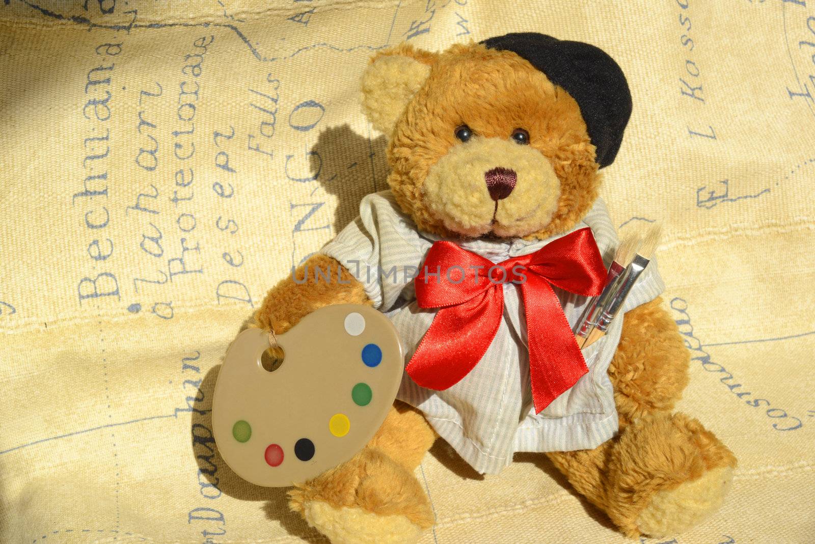 teddy bear sitting with palette and brushes