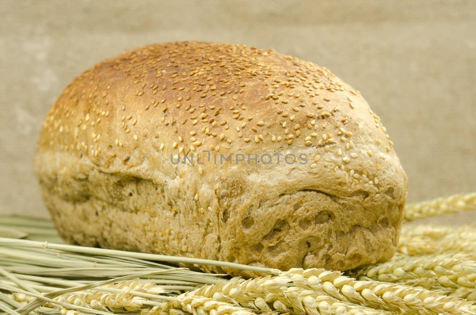loaf of bread with ears of wheat