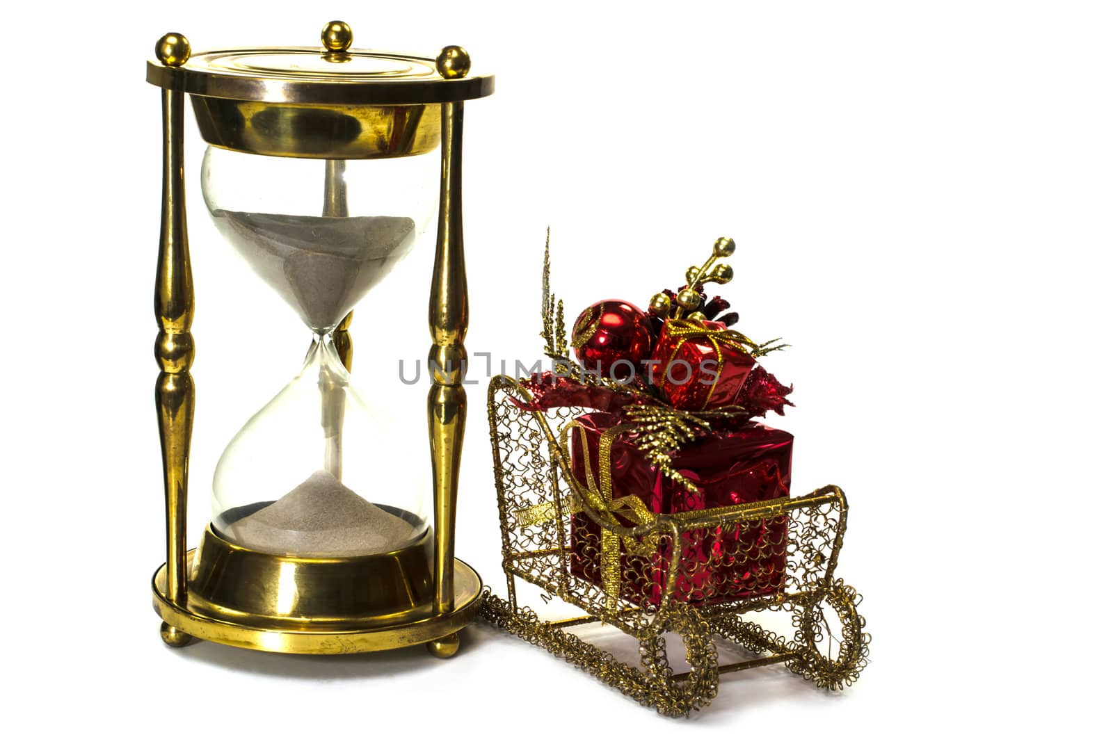 Christmas gift on sleigh and hourglass on white background.  Concept showing time running out for Christmas shopping.
