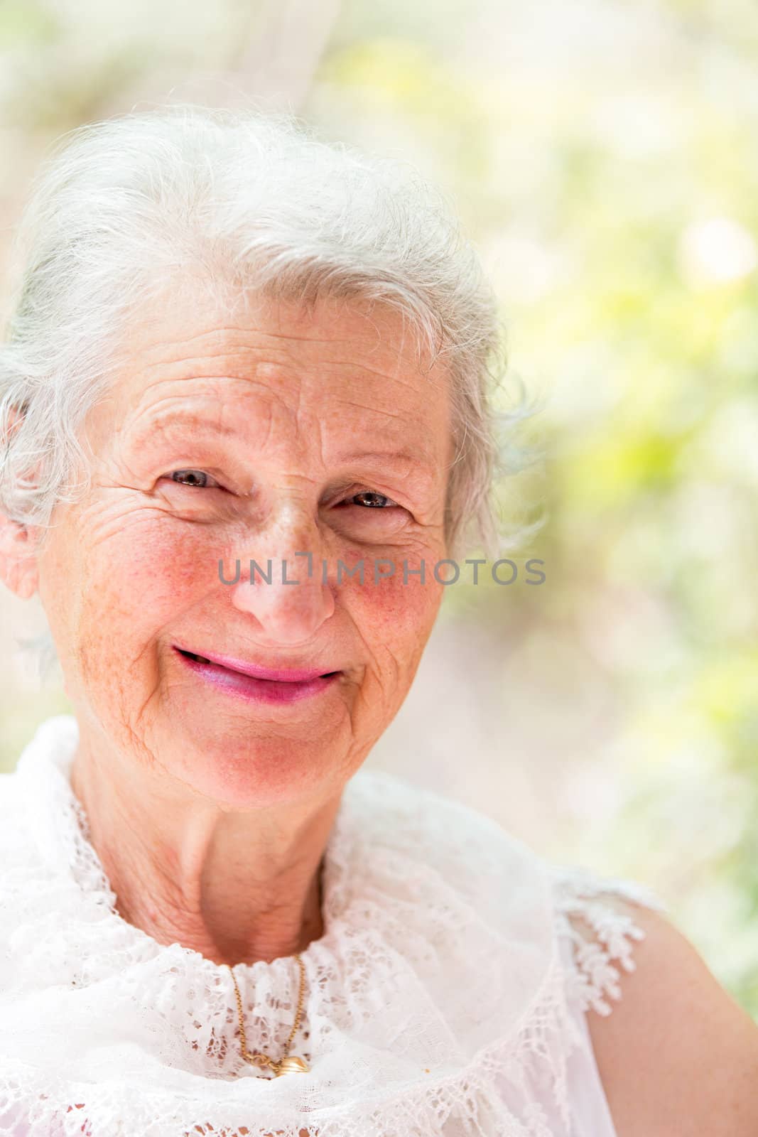 Grandmother looking at you confidently with her white hair and complimenting nice clothing.