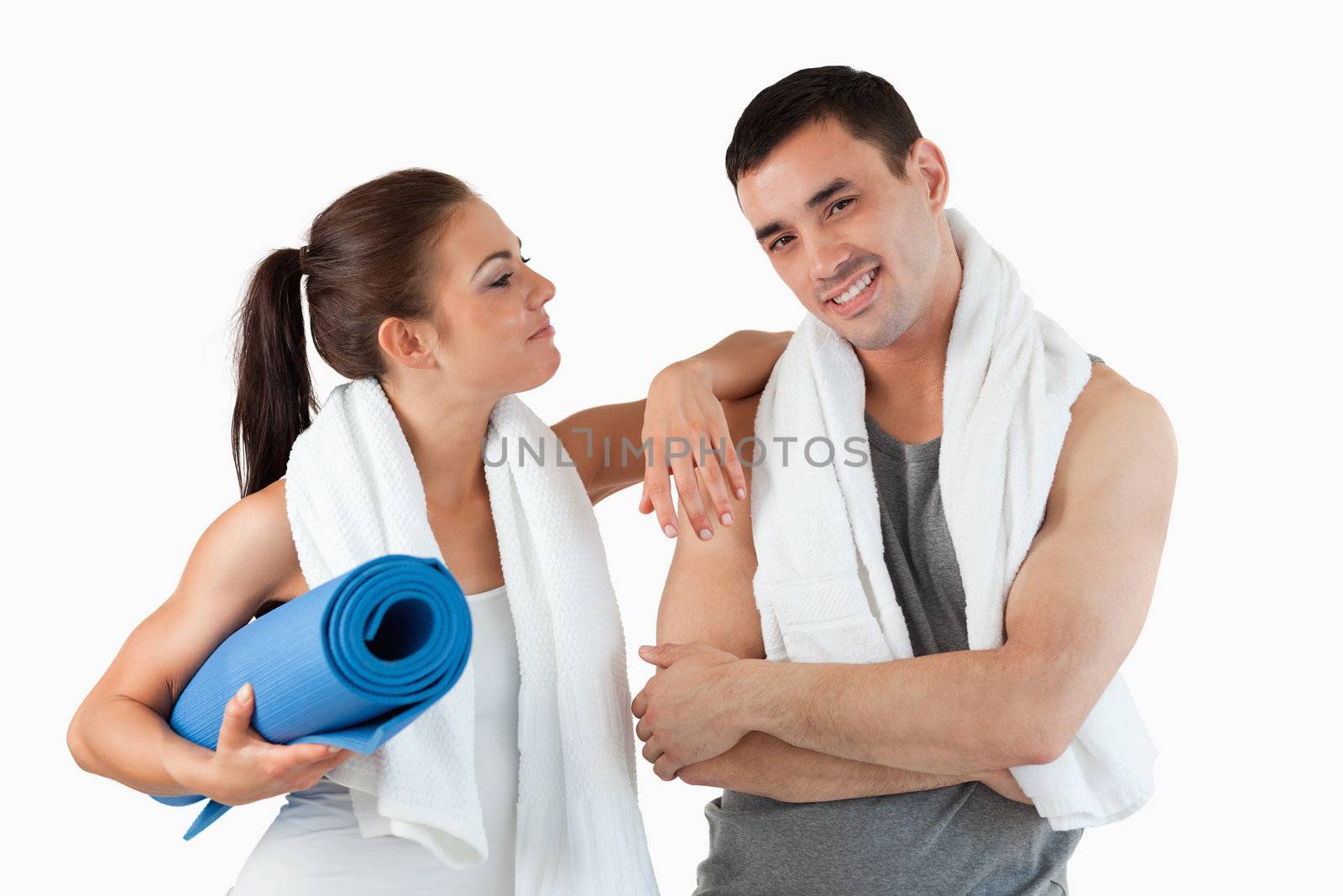 Young couple going to practice yoga against a white background