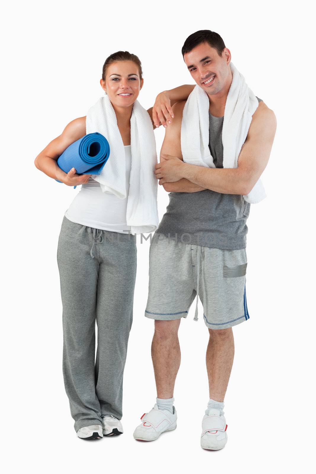 Portrait of a couple going to practice yoga against a white background