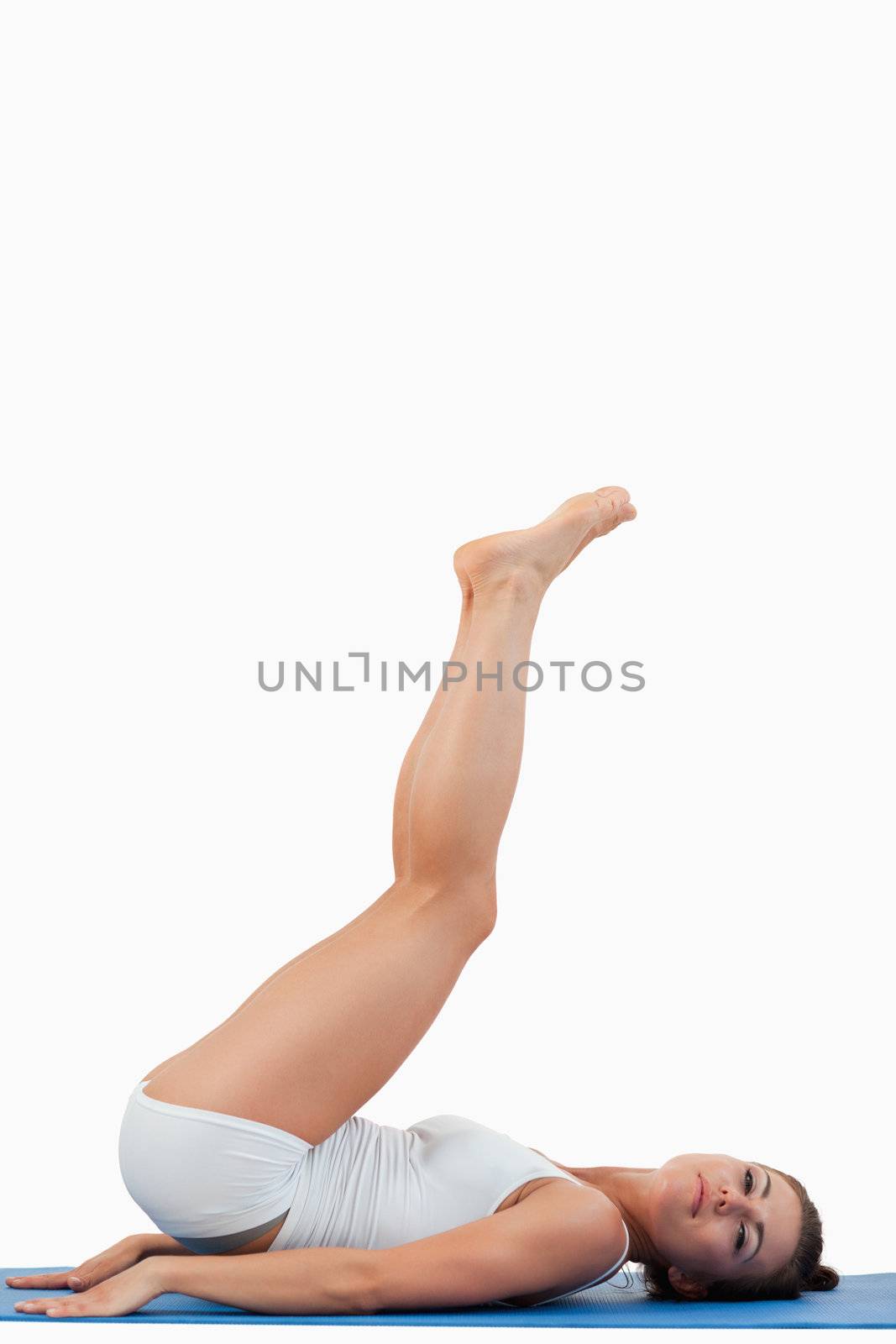 Portrait of a young woman exercising against a white background