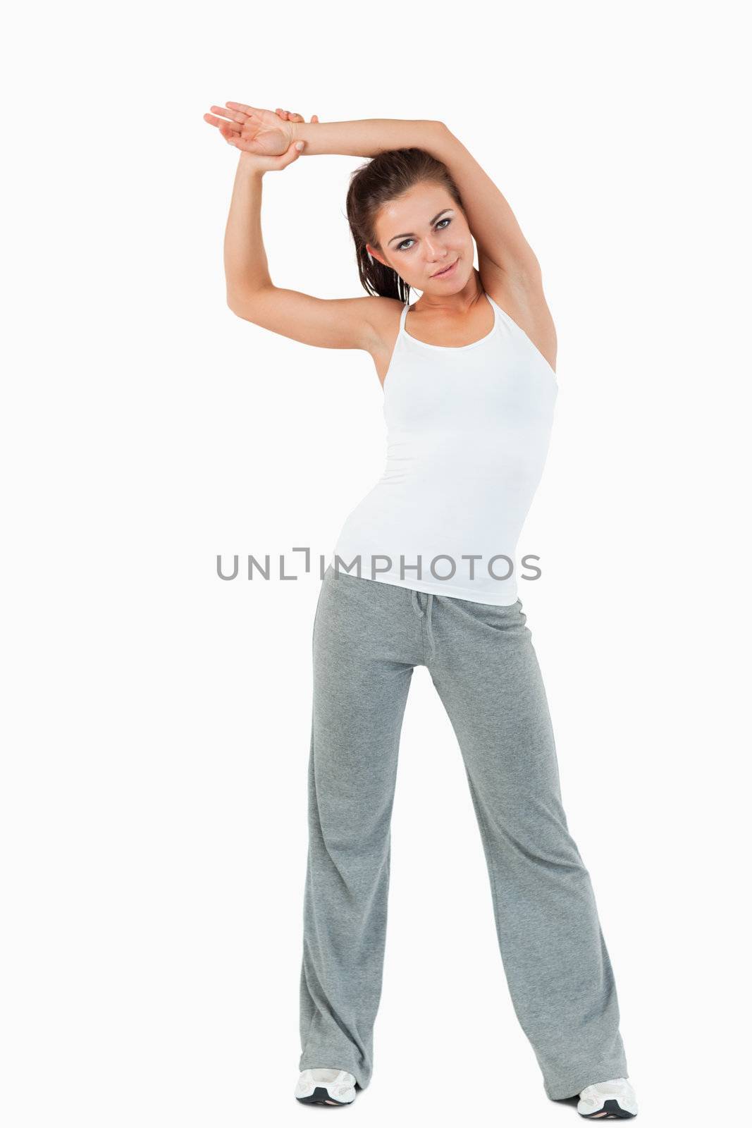 Portrait of a sports woman stretching her arms by Wavebreakmedia