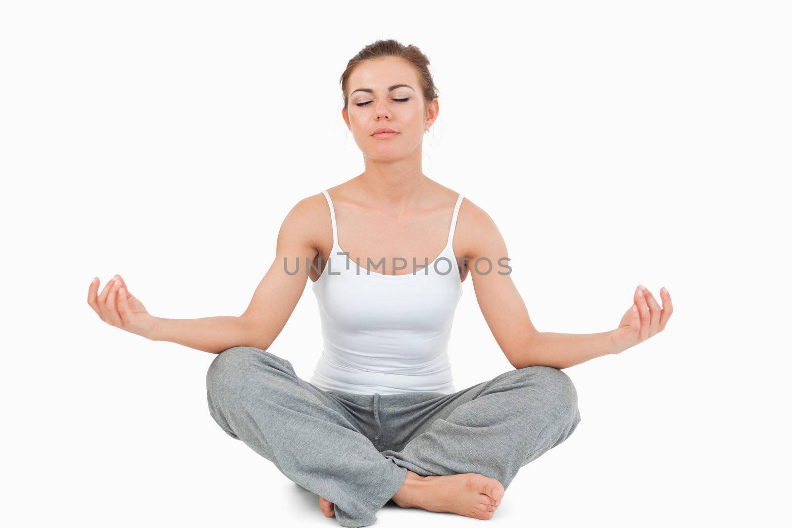 Woman in the Sukhasana position against a white background