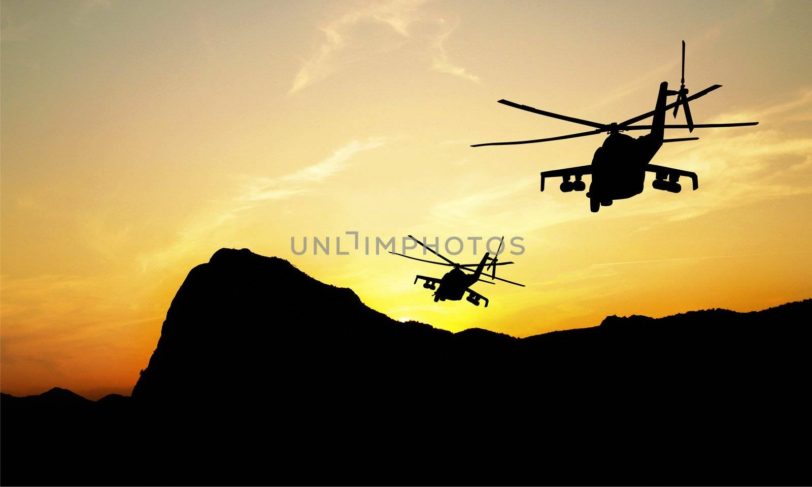 Flying helicopter silhouettes on sunset background