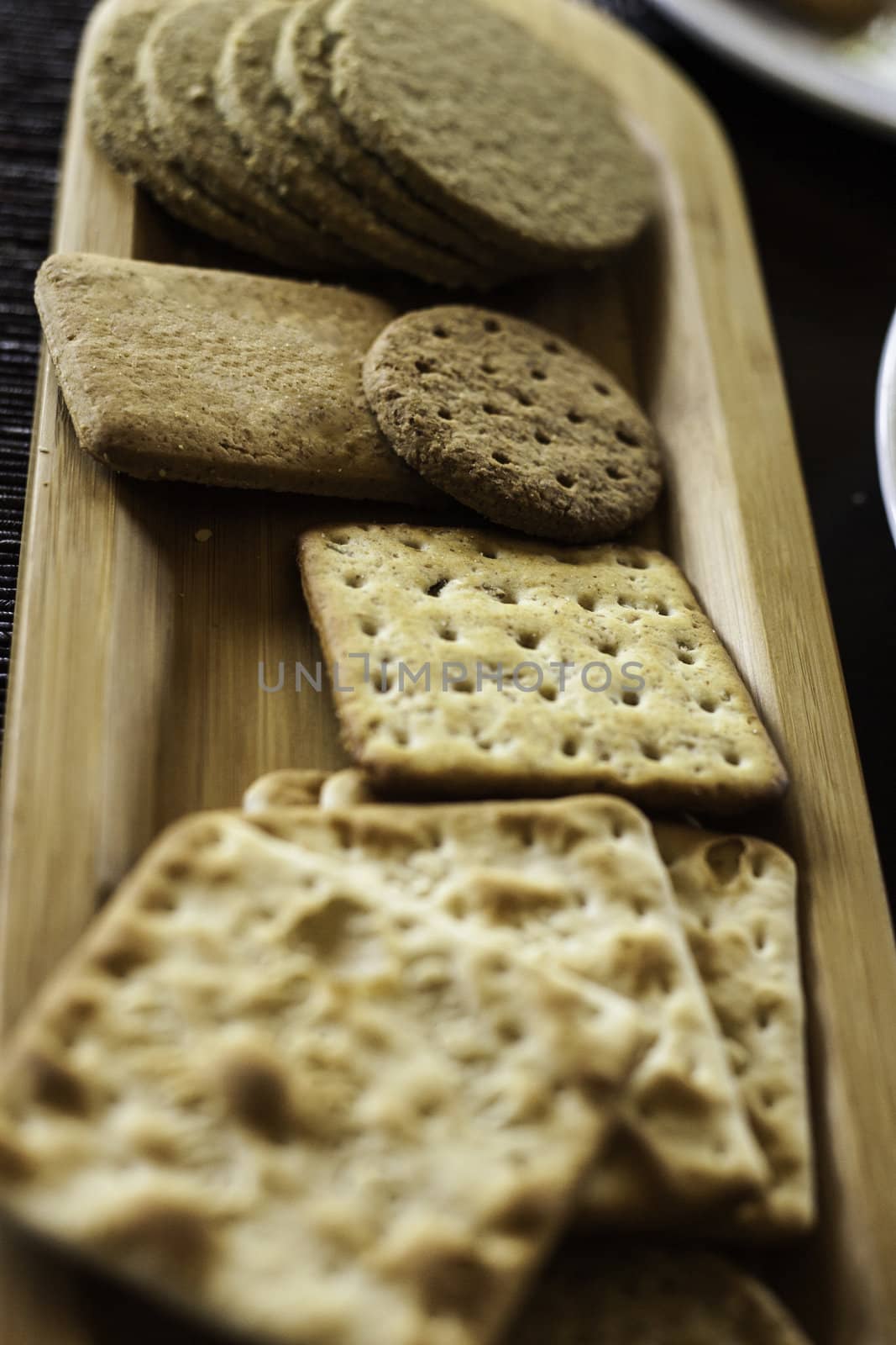 Various biscuits on a wooden plate - selective focus