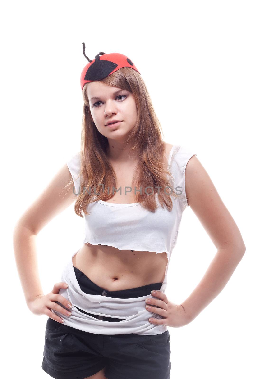A girl in a torn T-shirt and cap, strange studio photography