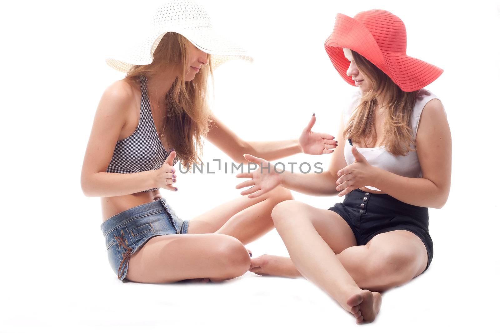 Two girls in summer hats studio photography