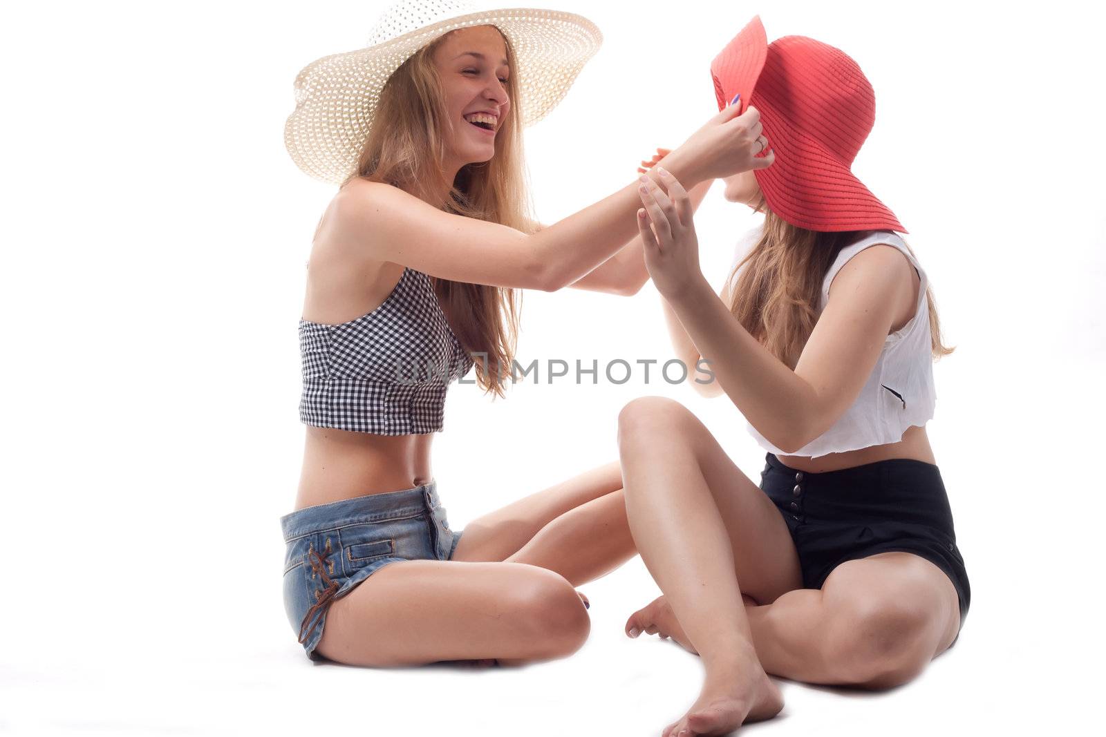 Two girls in summer hats studio photography