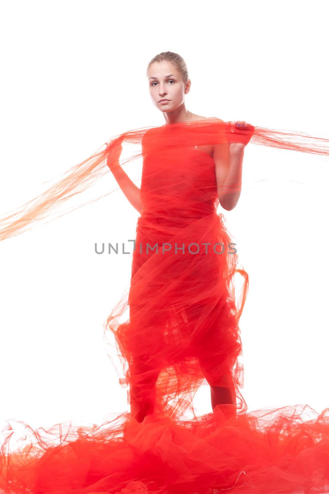 Beautiful girl in a red cloth studio shooting