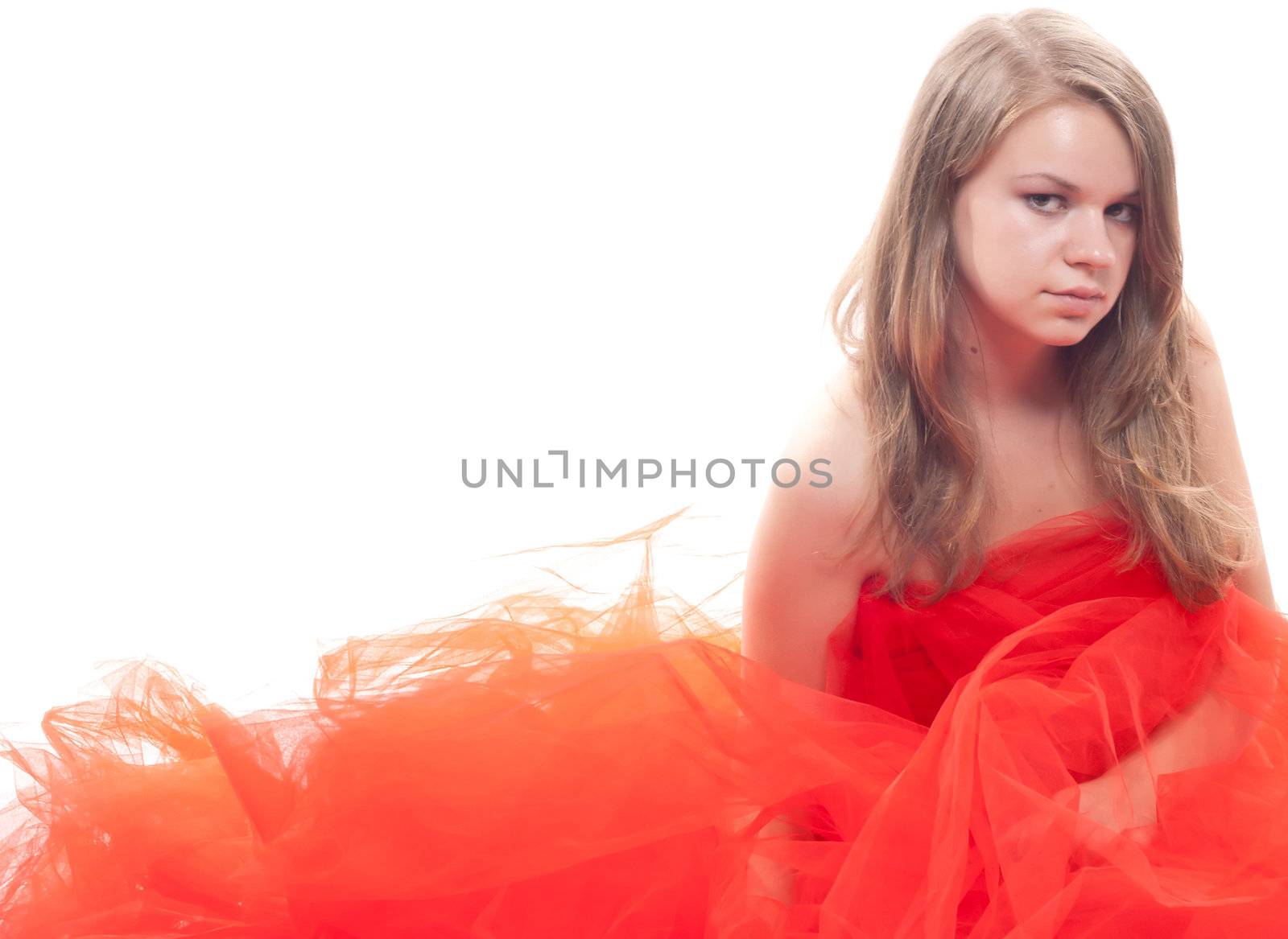 Beautiful girl in a red cloth studio shooting