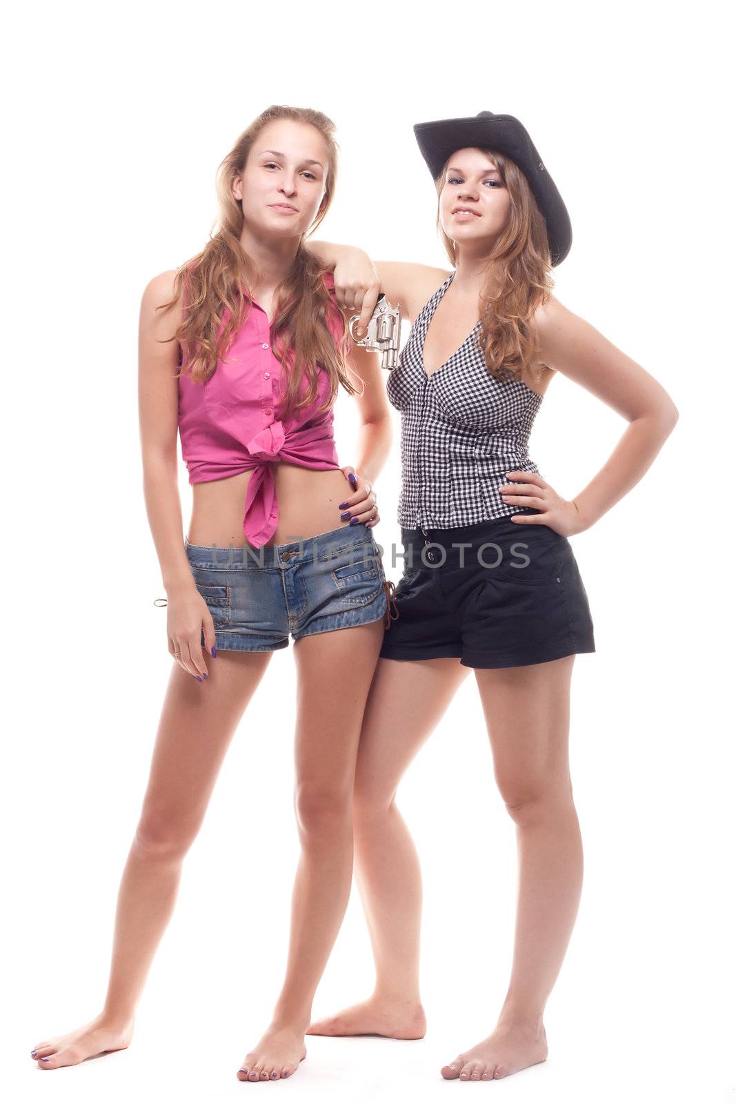 Portrait of two young girls with a gun shooting studio