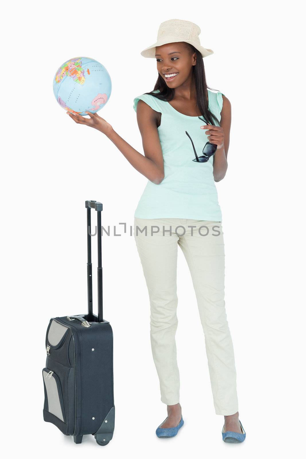 Young woman ready to travel the world against a white background