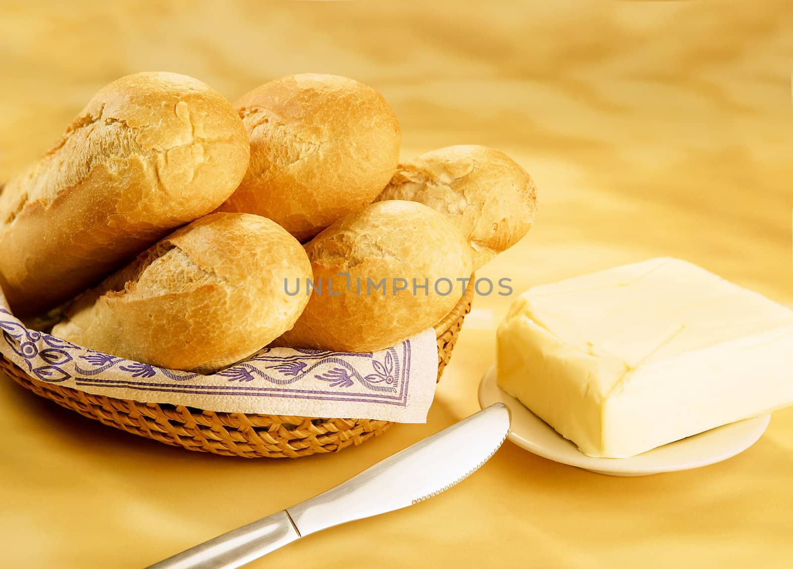 Baguettes in a basket and butter brick by hanusst