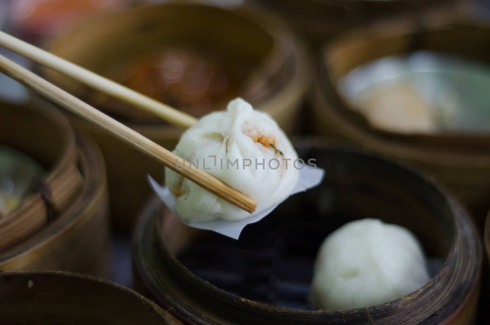 chopsticks holding chinese bun - dimsum chinese breakfast