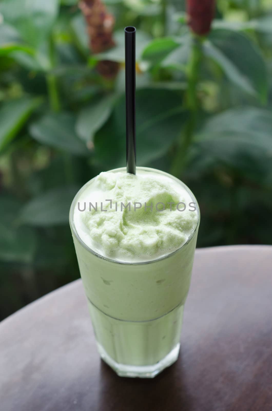 green tea milk shake in glass on table at restaurant