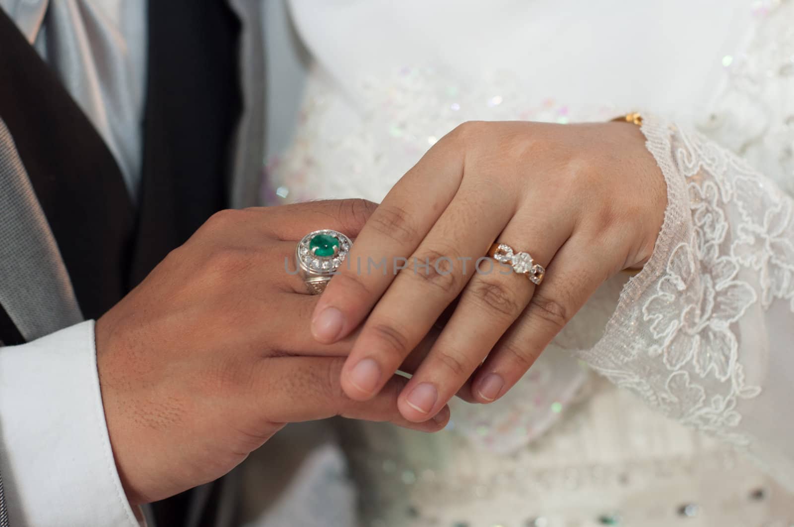 wedding lovers hand holding with diamond rings by ngarare