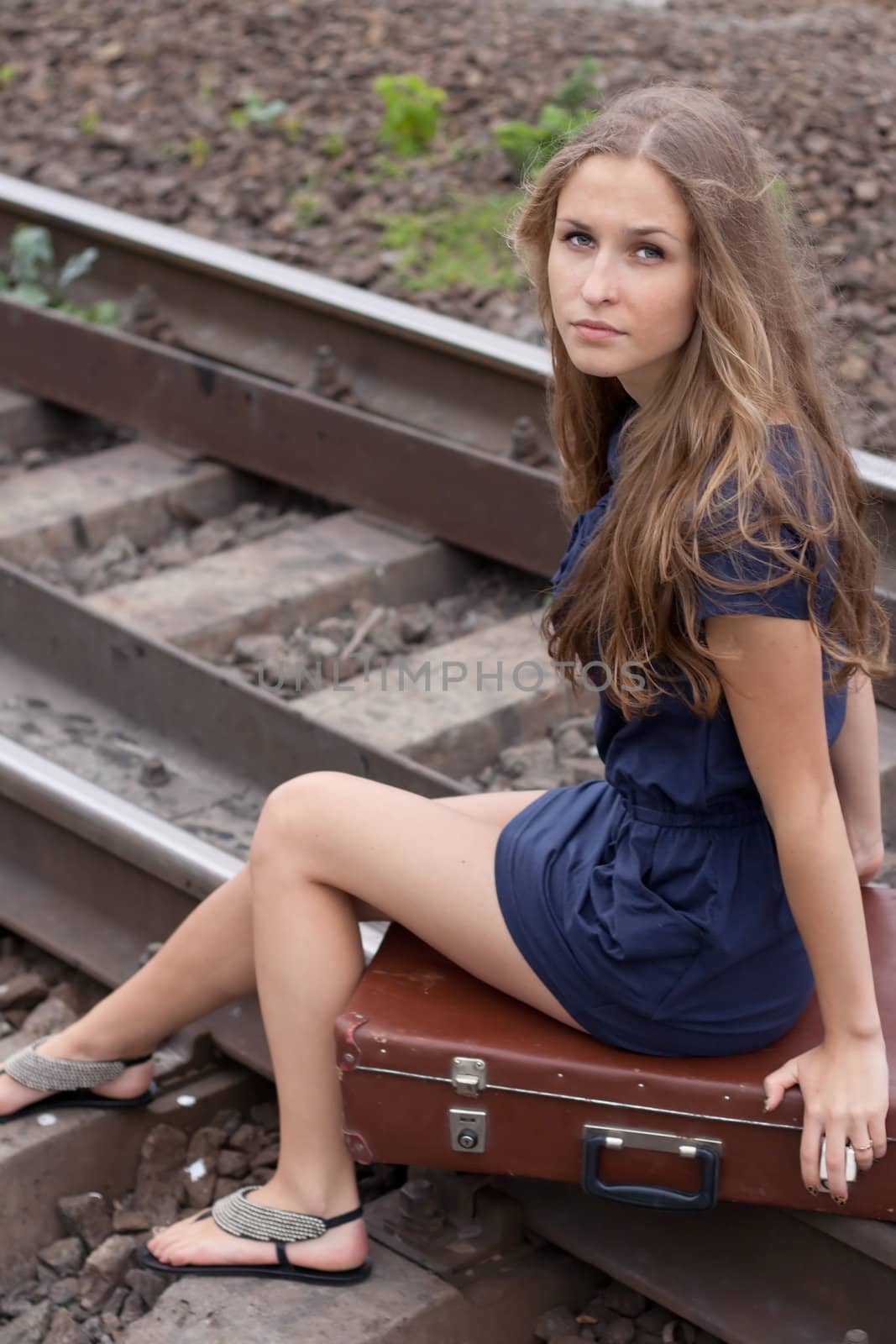 Woman sitting on rails outdoors shooting