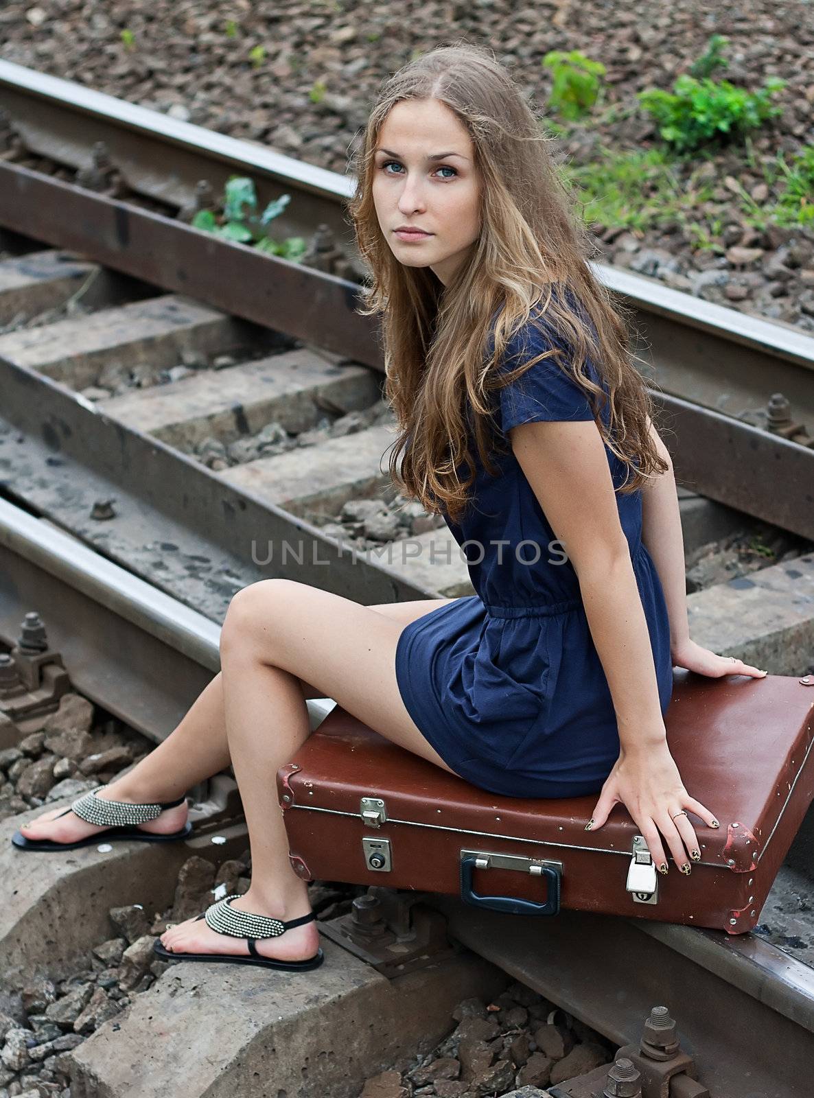 girl sitting on the rails with a suitcase Shooting outdoors by victosha
