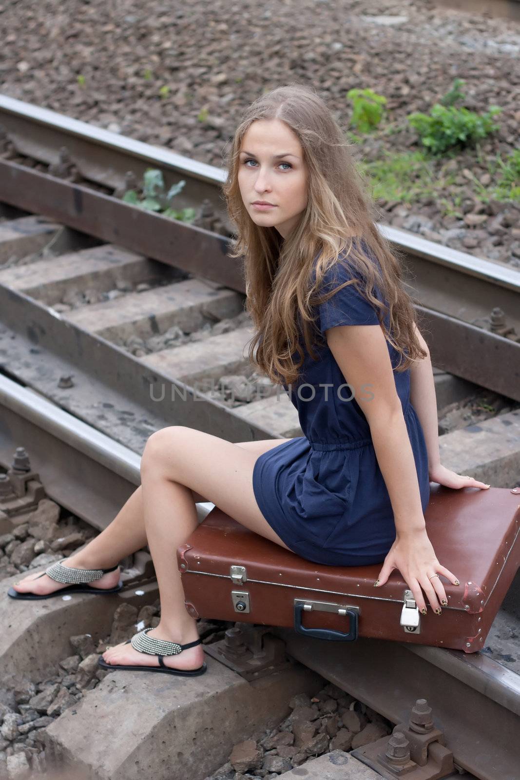 Woman sitting on rails outdoors shooting