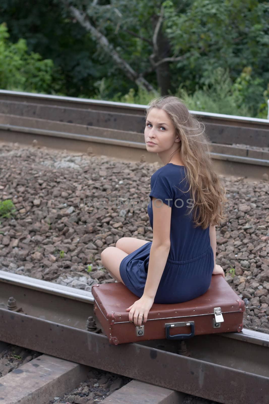 Woman sitting on rails outdoors shooting