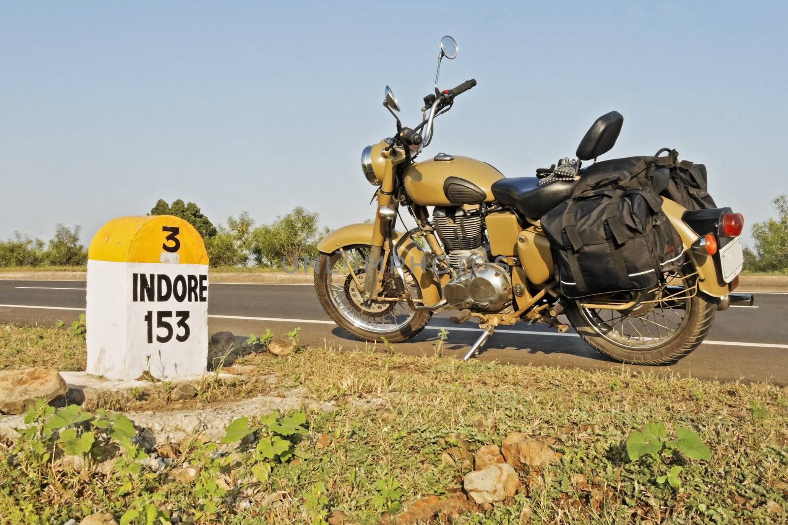 Indian motorcycle parked on NH3 Mumbai Agra Road at the 153kms milestone in the hinterlands of India