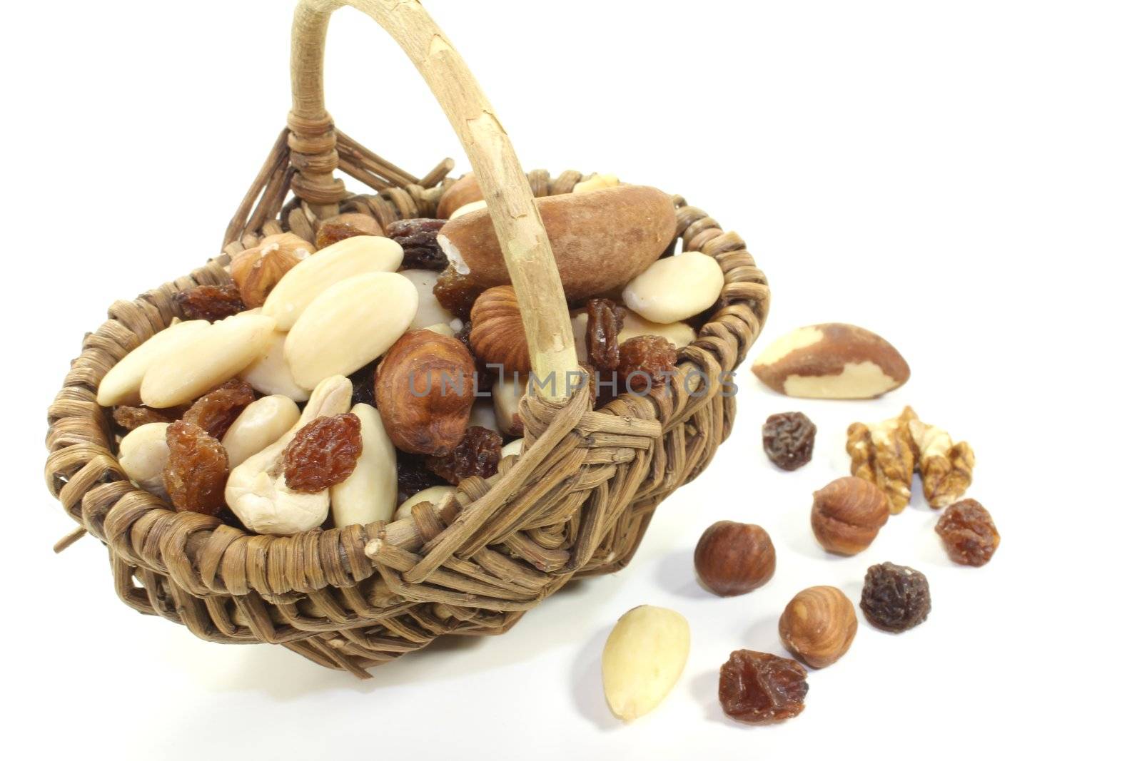 crunchy mixed nuts and raisins as a snack on a bright background
