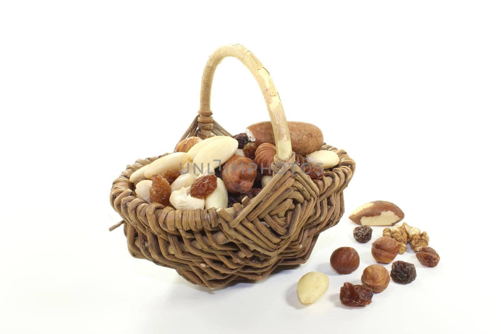 fresh mixed nuts and raisins as a snack on a bright background