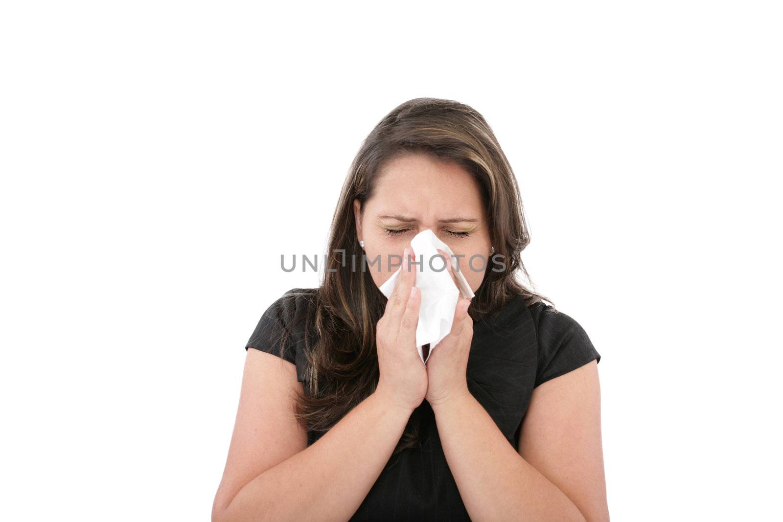 A woman with a cold or allergy wiping or blowing her nose.