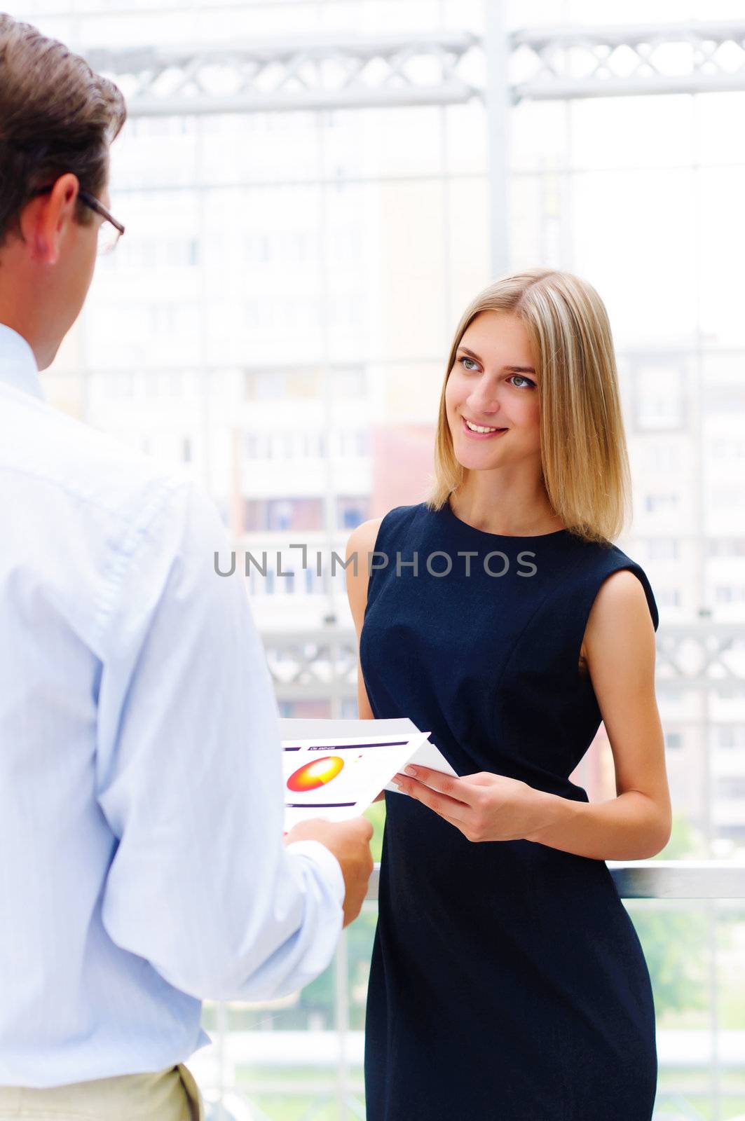 business man and business woman in the office to discuss reports by adam121