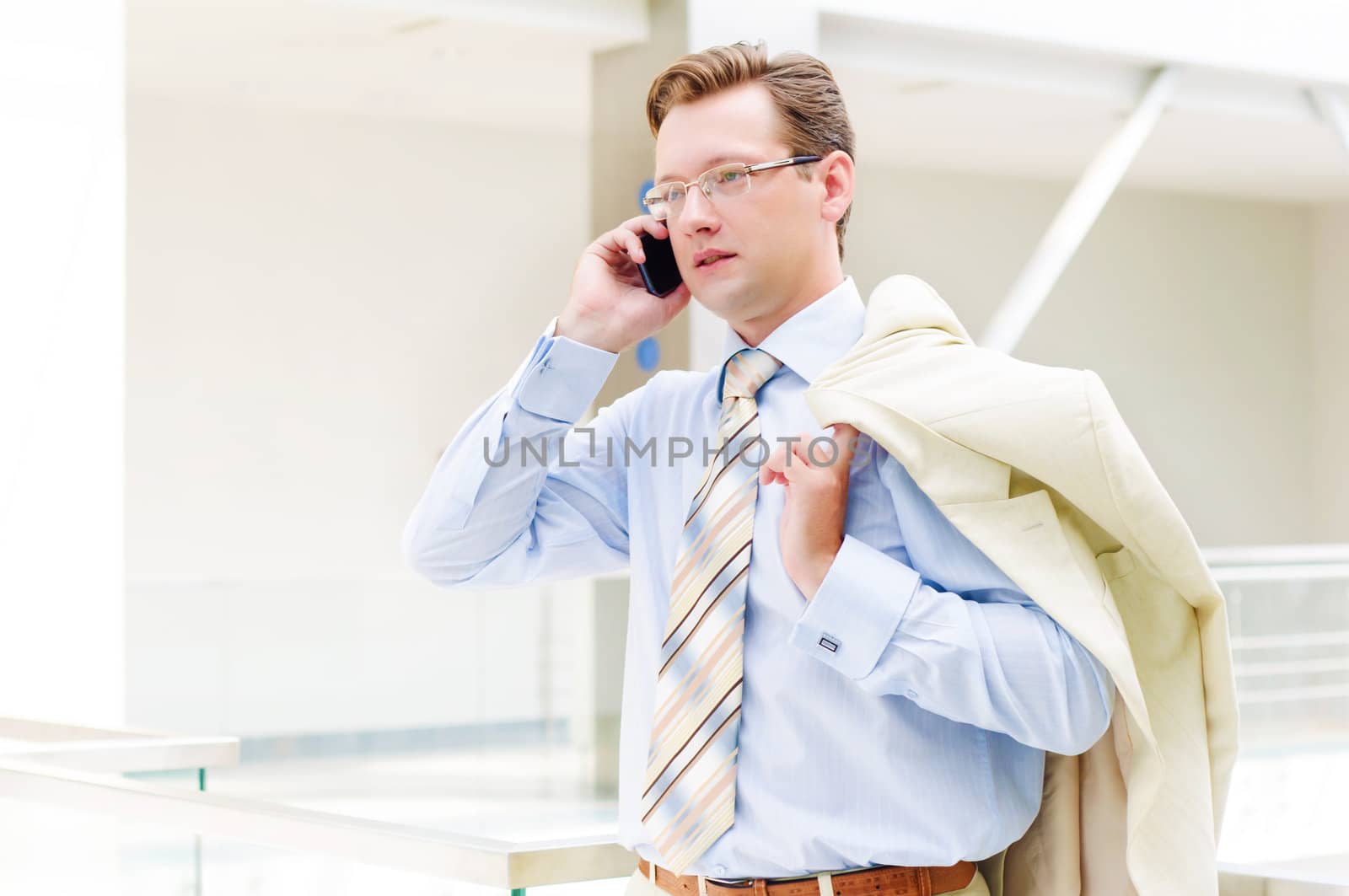 Smiling business man, talking on cell phone